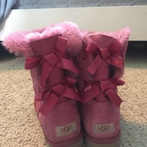 Pink UGG boots with bows going up back